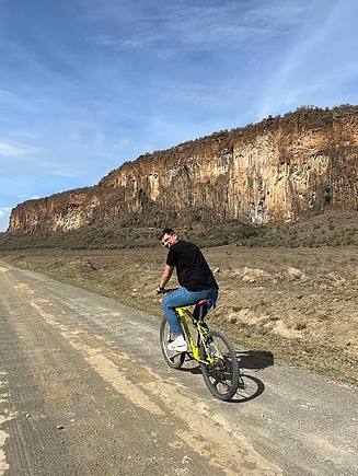 Young man on bicycle, looking over shoulder