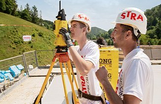 Photo: An apprentice looks through a measuring device