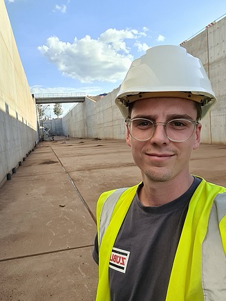 Selfie eines jungen Mannes mit Bauhelm