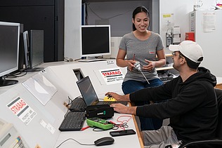 Two colleagues in conversation together at the workplace