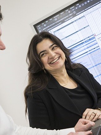 Photo technician in office looks at plan