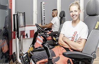 Photo Anne Killmer smiles in the excavator simulator