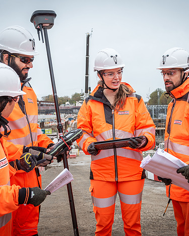 People on the construction stand together